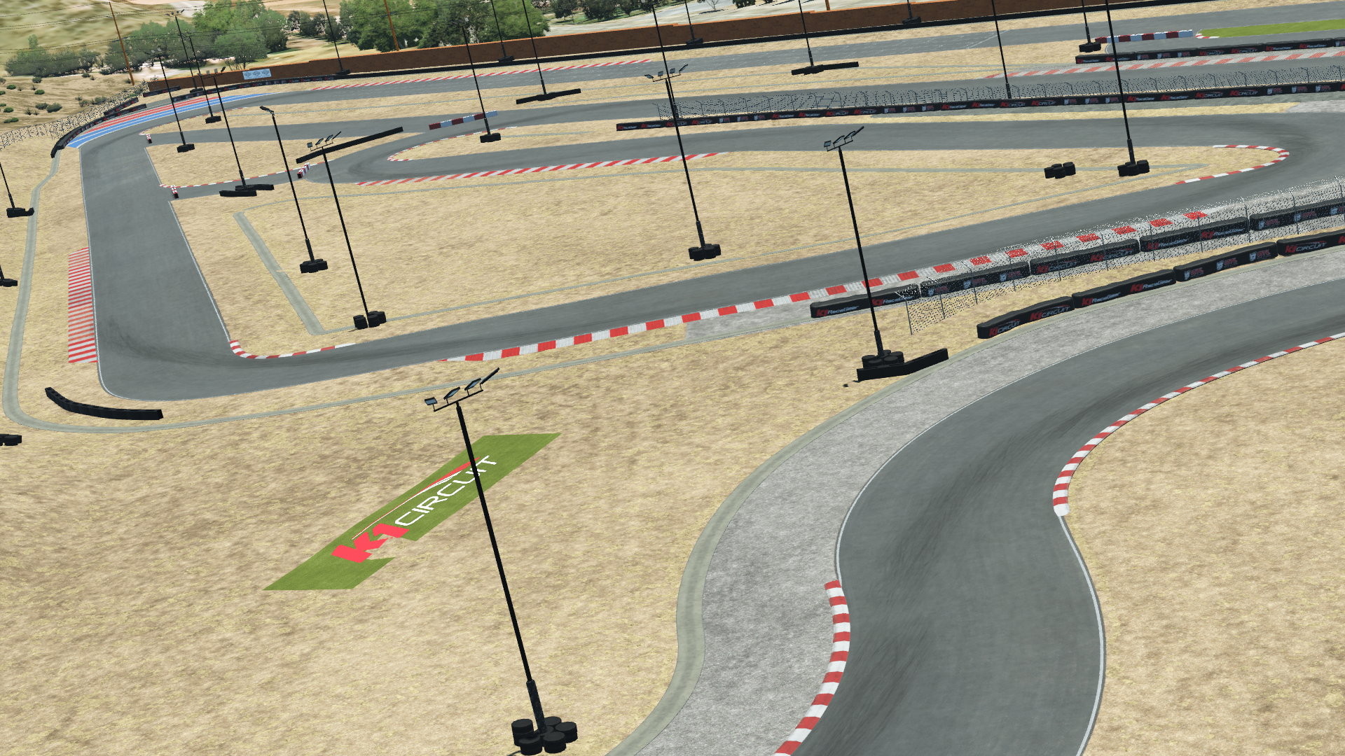 K1 Winchester karting track render – red and white curbs, desert terrain, light poles, and branded run-off area