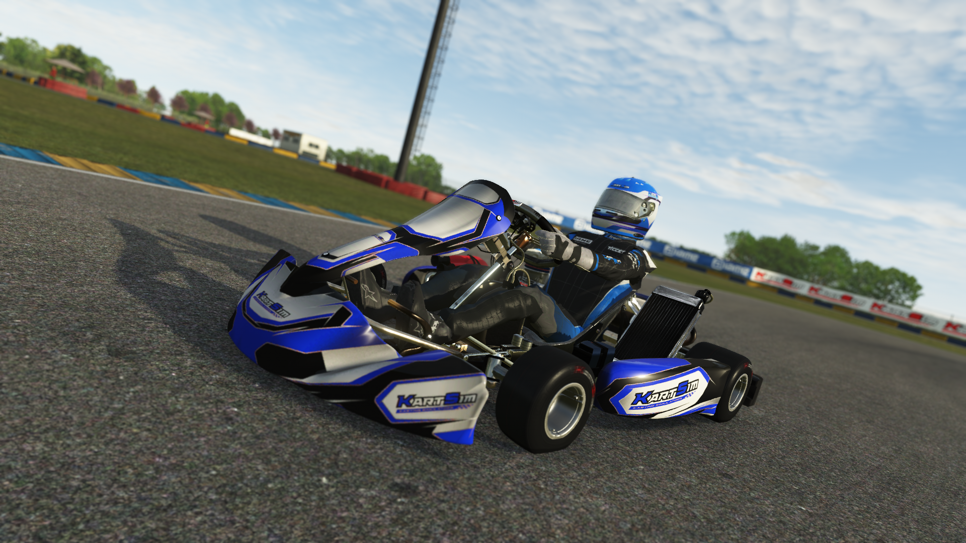 Side view of Junior OK kart racing on a smooth track with greenery in the background, rendered in KartSim kart simulation software