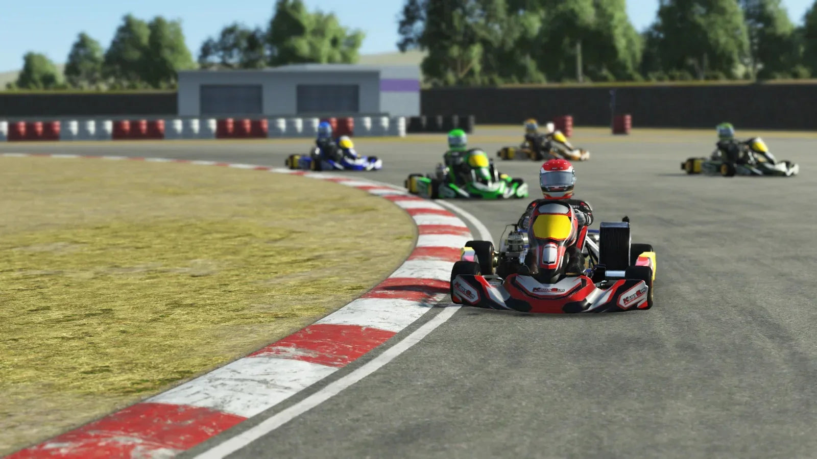A KartSim simulated race showing multiple go-karts, with the lead kart in red and black livery taking a sharp right-hand corner on a track with red and white curbs, closely followed by karts in green, blue, and yellow liveries.