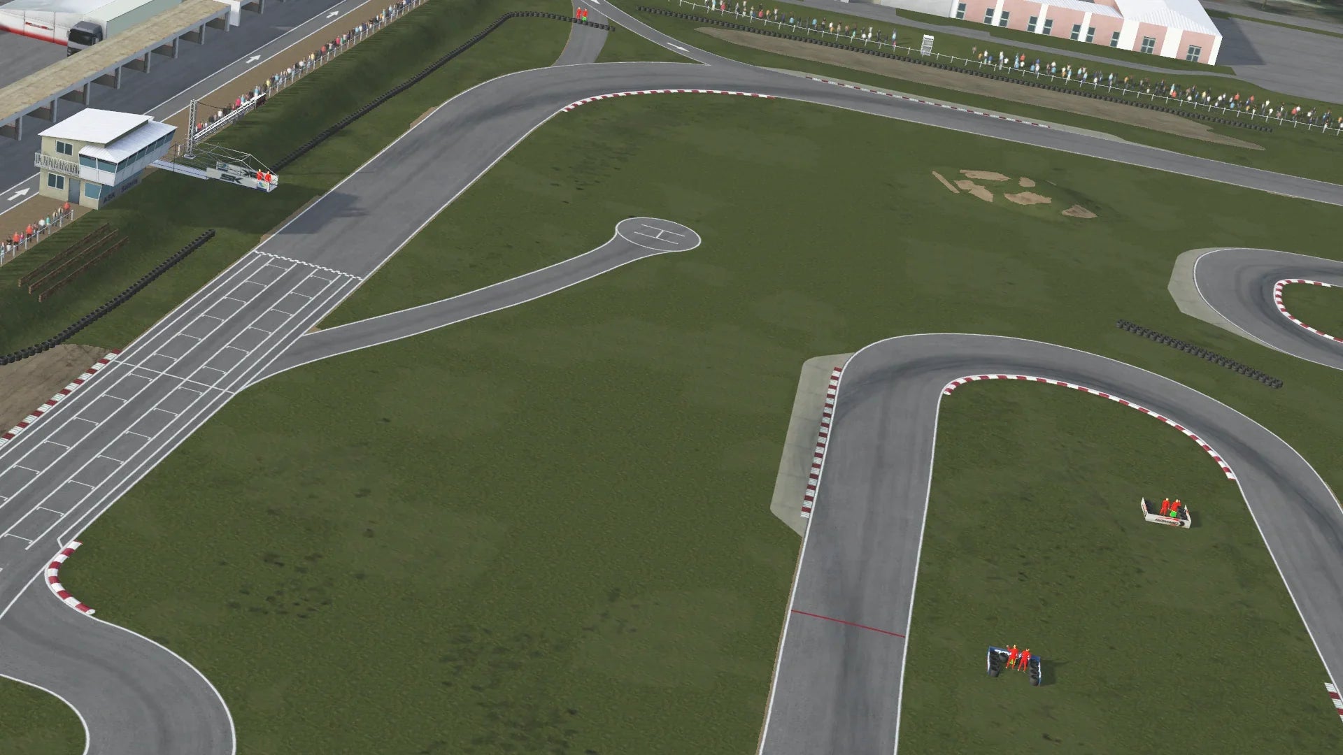 High-angle in-simulation view of the Salbris karting circuit in KartSim software, showing the start/finish straight with pit building on the left, winding asphalt track with red-white kerbs, grass run-off areas, tire barriers, and spectator stands under a clear sky.