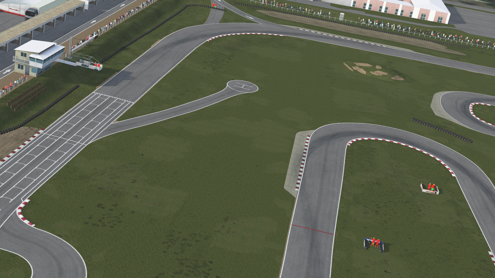 High-angle in-simulation view of the Salbris karting circuit in KartSim software, showing the start/finish straight with pit building on the left, winding asphalt track with red-white kerbs, grass run-off areas, tire barriers, and spectator stands under a clear sky.