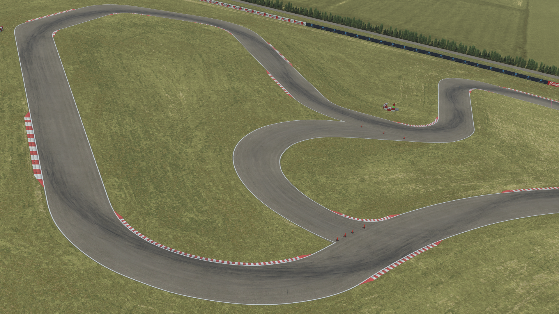 Aerial view of Zuera kart racing circuit with multiple curves and grassy surroundings in KartSim kart racing simulation software