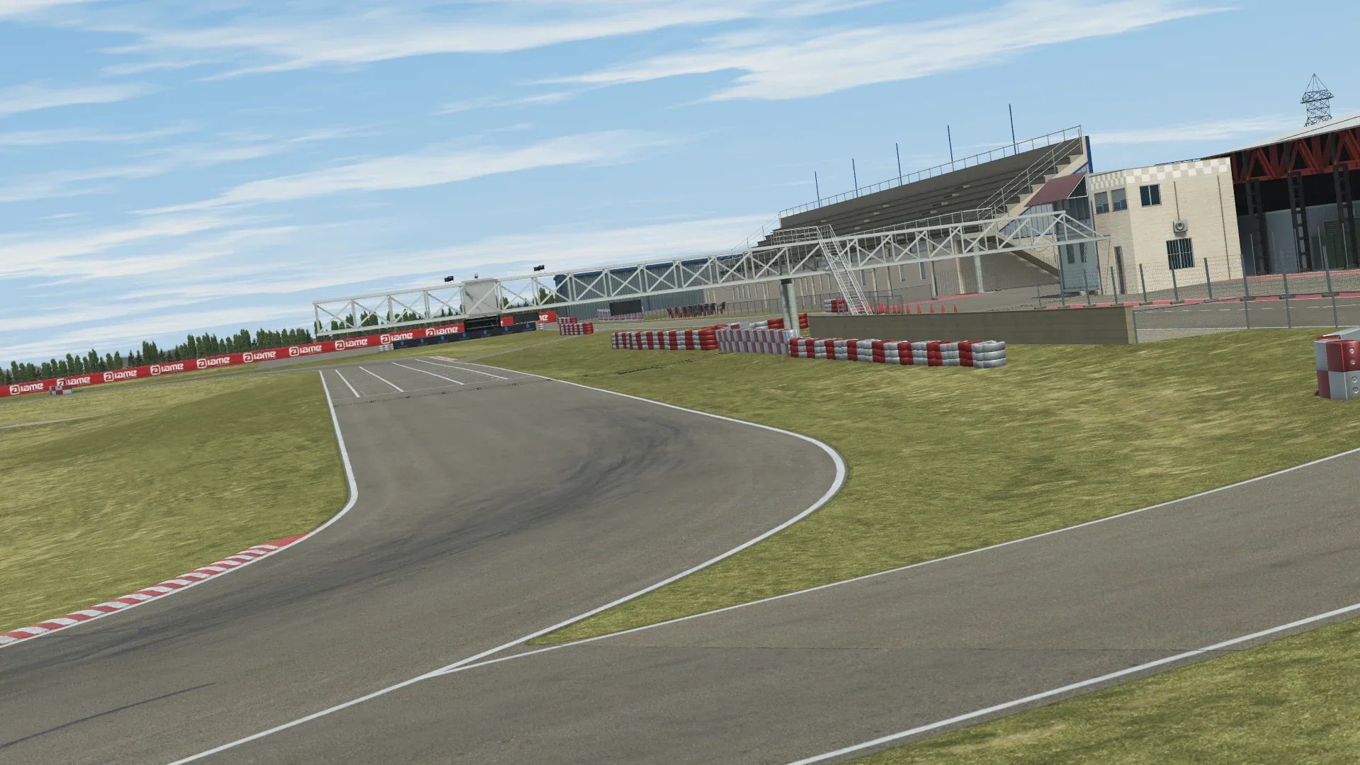 The image features a race track surrounded by lush grass under a clear blue sky. The scene showcases the track and viewing area, emphasizing an outdoor racing environment. This vibrant setting is perfect for motorsports enthusiasts and outdoor events.