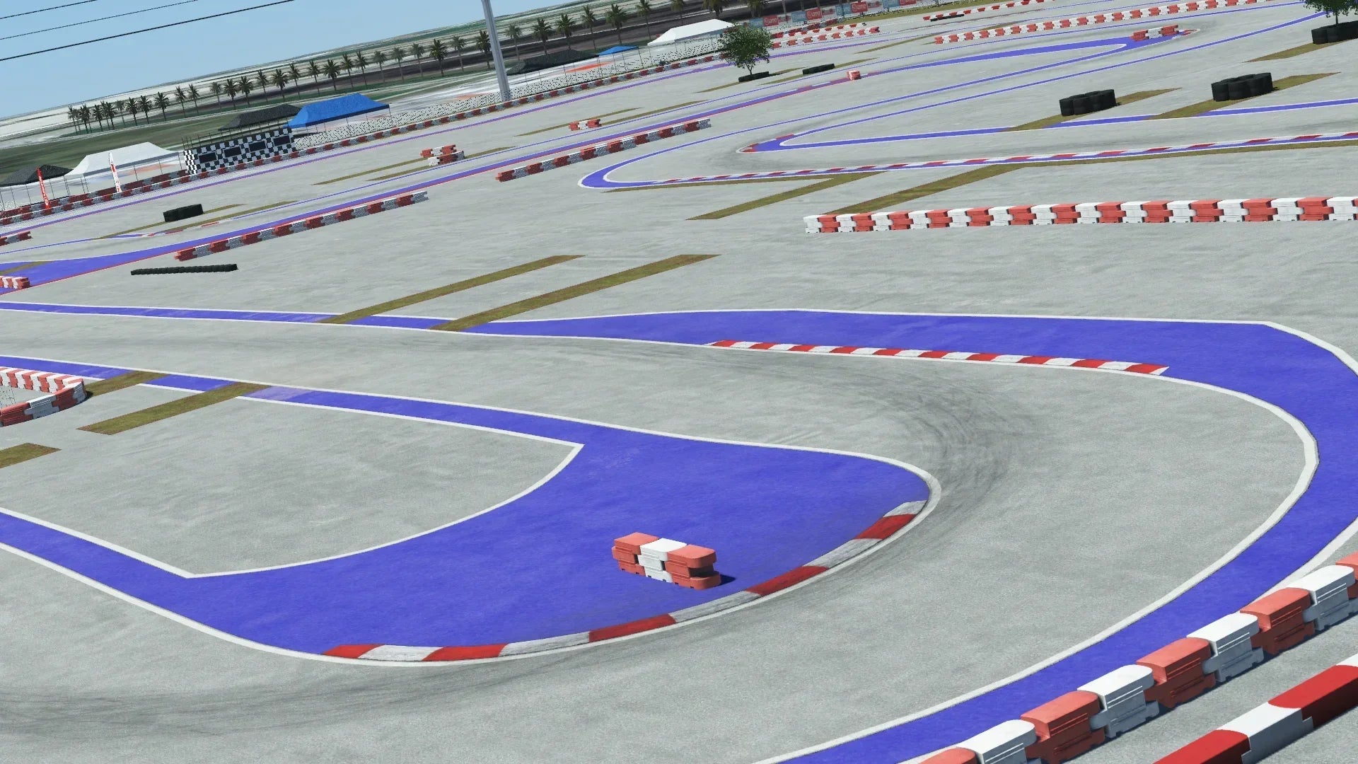 Urban kart track with red and white barriers, purple runoff areas, and a clear concrete surface