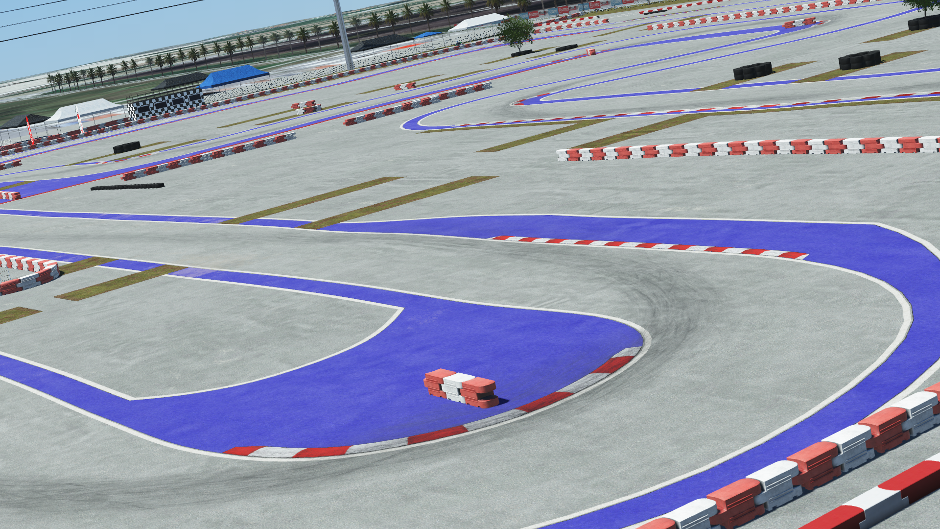 Urban kart track with red and white barriers, purple runoff areas, and a clear concrete surface