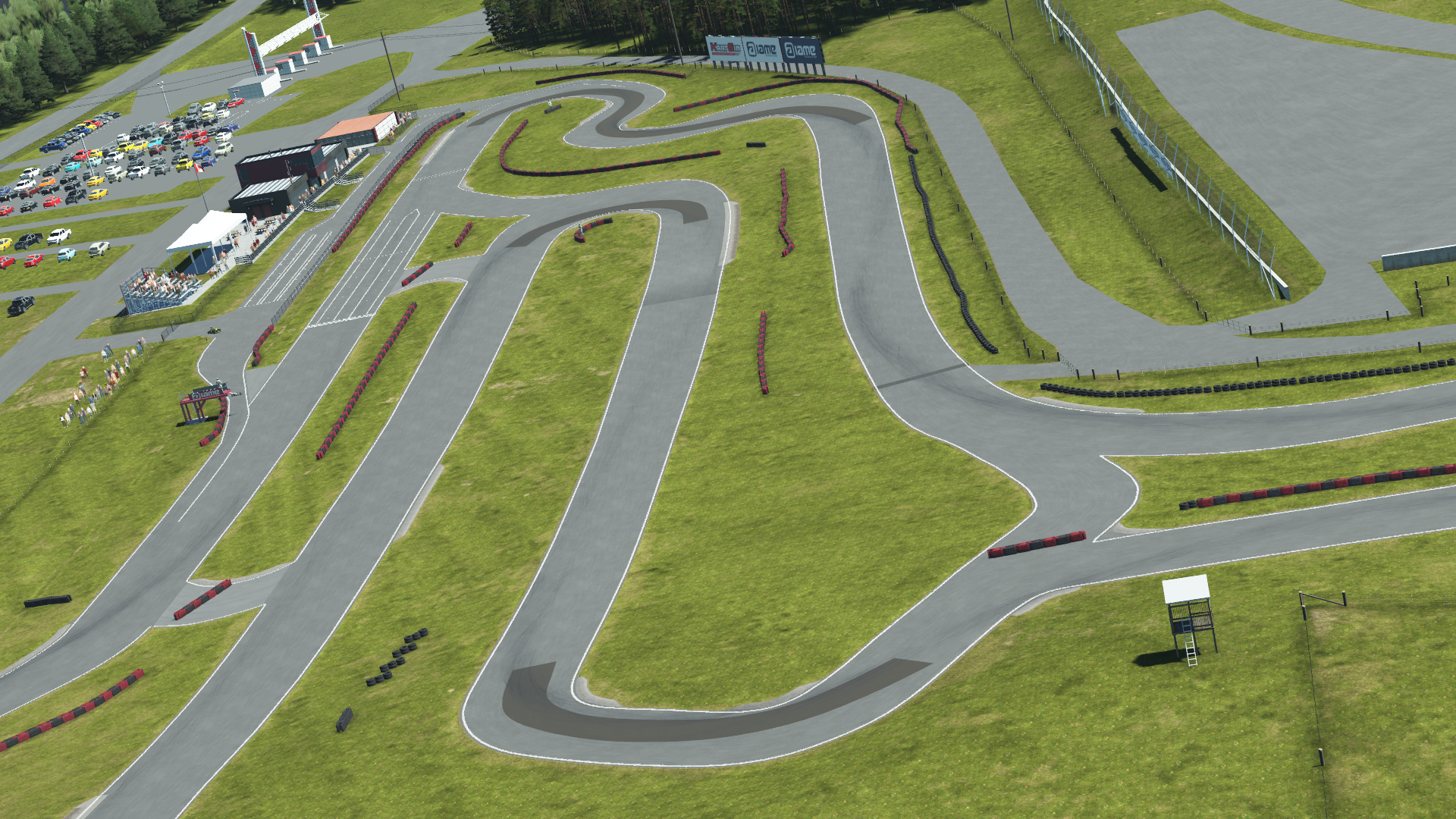Aerial view of Mosport karting track with winding tarmac layout, barriers, grassy terrain, and paddock area with spectators