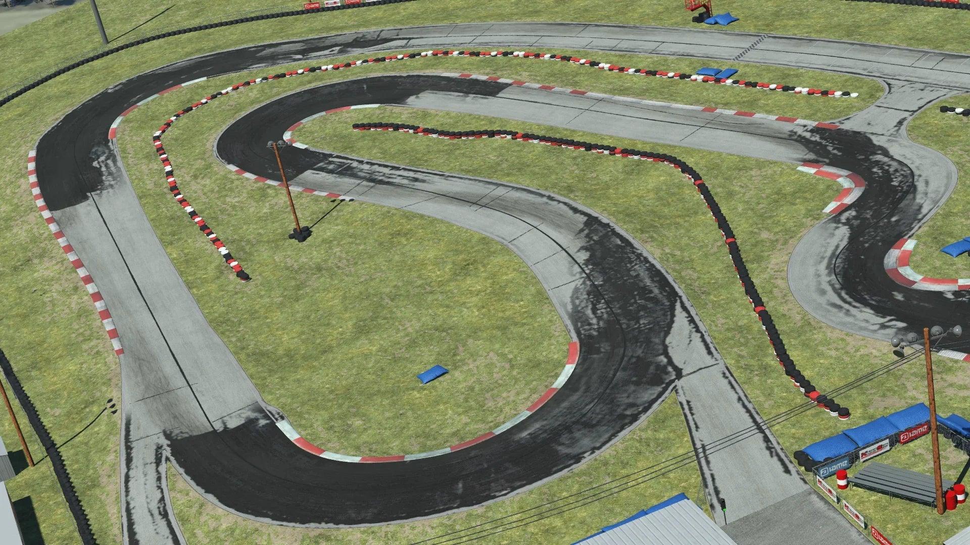 Overhead view of North Texas go-kart circuit with sharp curves, red and white barriers, and grassy terrain