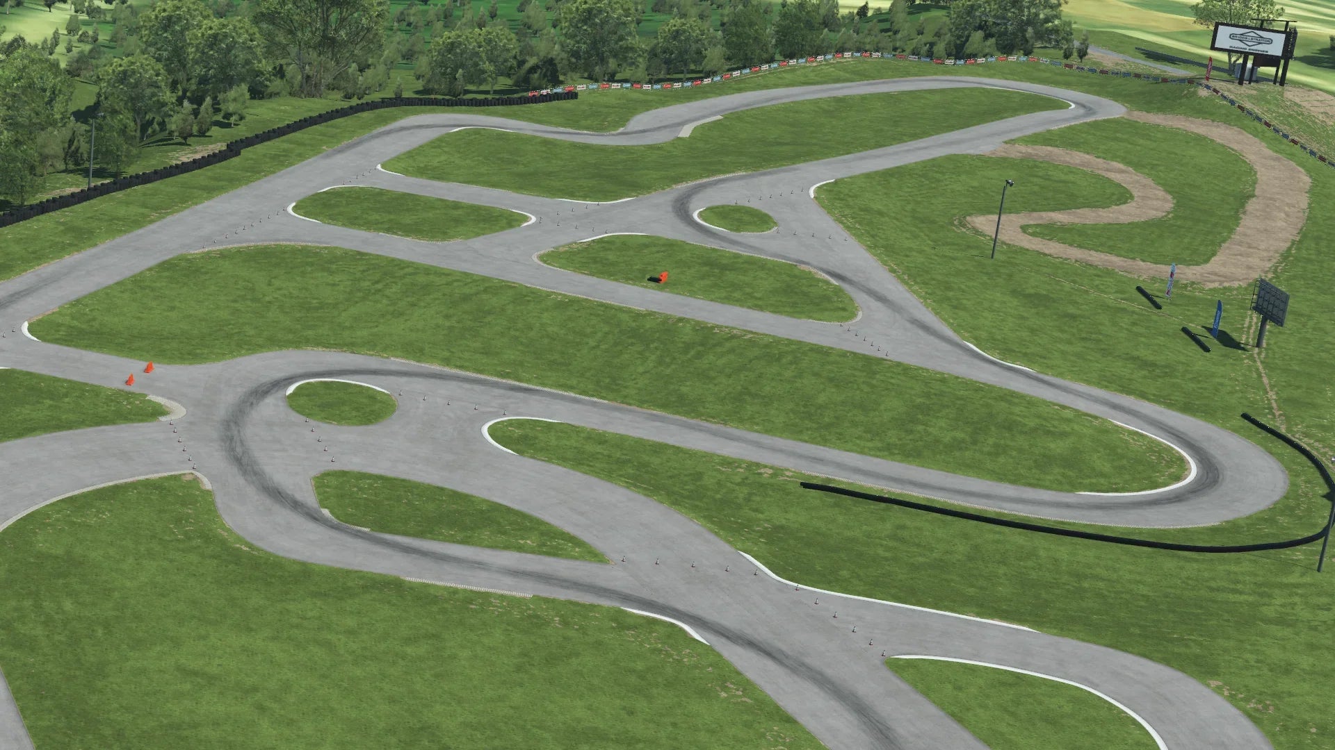 Overhead view of Road America kart track with winding asphalt layout on green grass and tree-lined background