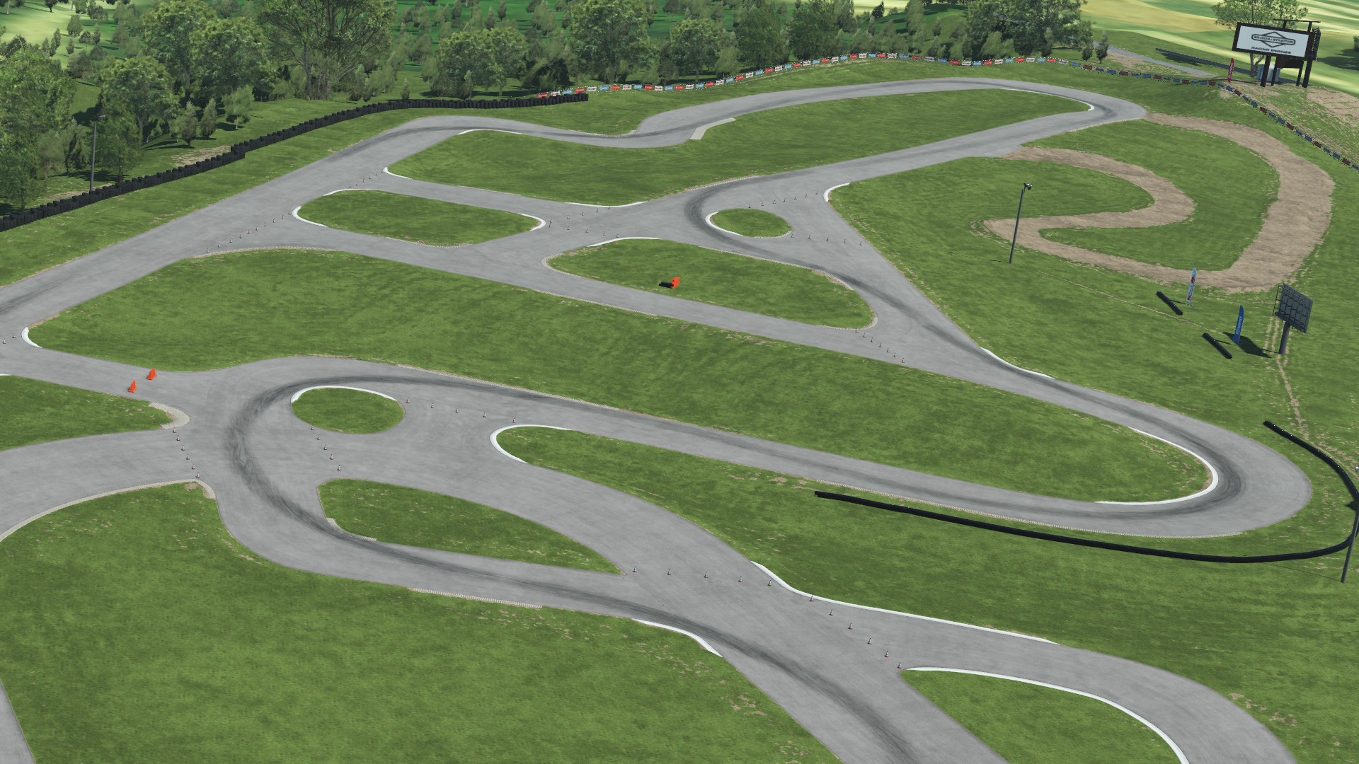 Overhead view of Road America kart track with winding asphalt layout on green grass and tree-lined background