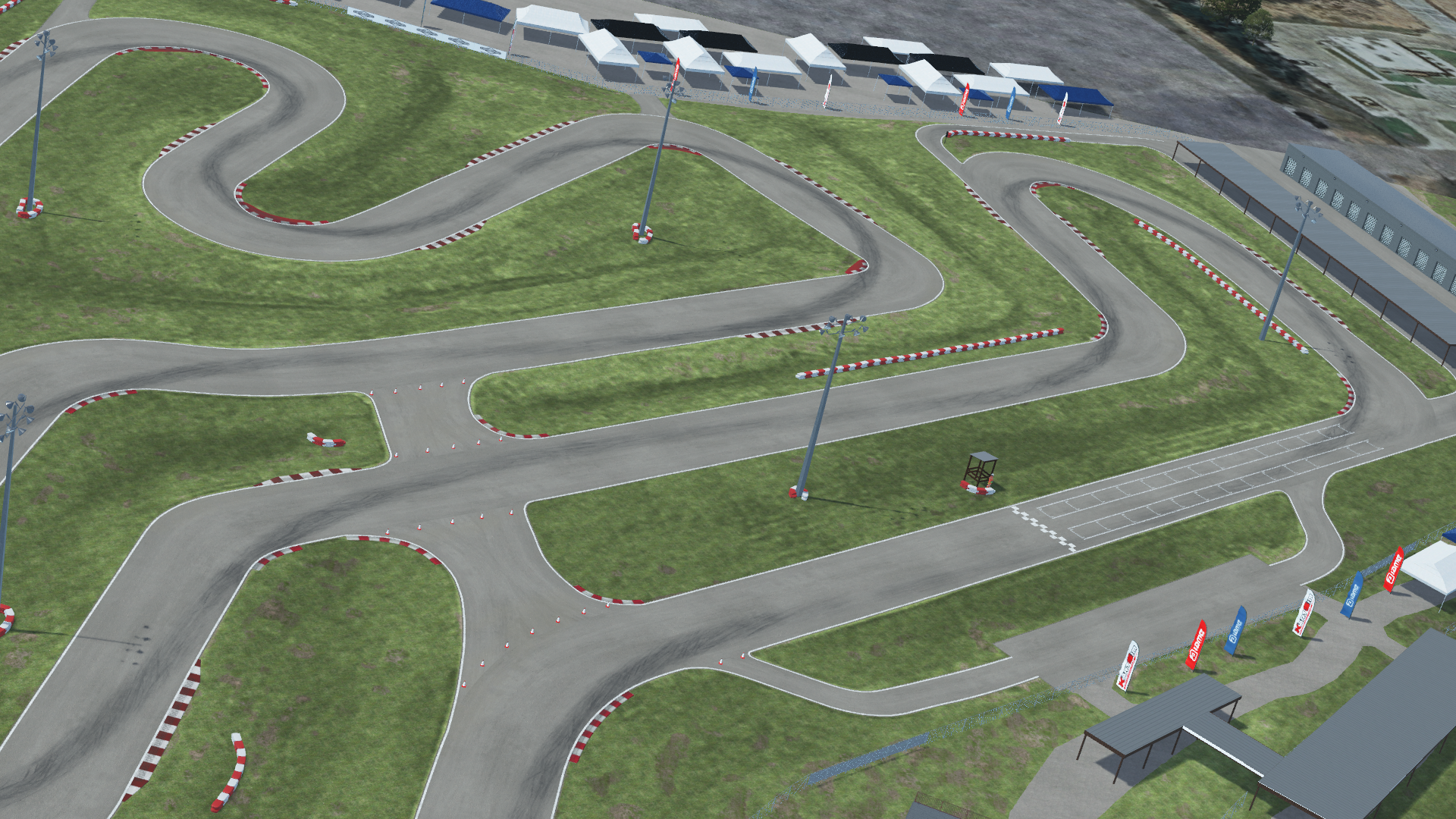 Aerial view of Speedsportz karting track with winding turns, red and white curbs, and grass infield, surrounded by paddock tents