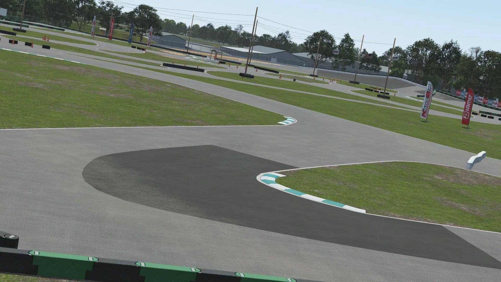 Whiteland karting circuit corner section – 3D-rendered view with green and white curbs, tire barriers, and sponsor banners