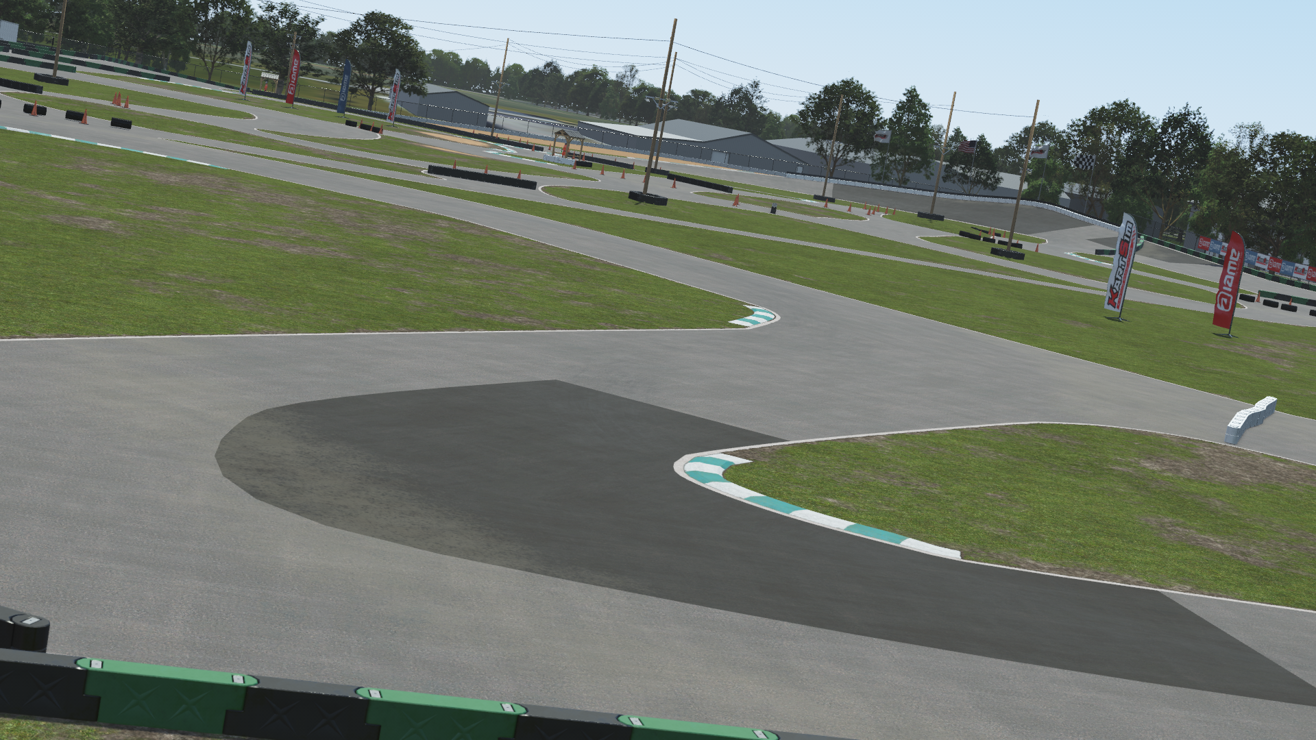 Whiteland karting circuit corner section – 3D-rendered view with green and white curbs, tire barriers, and sponsor banners